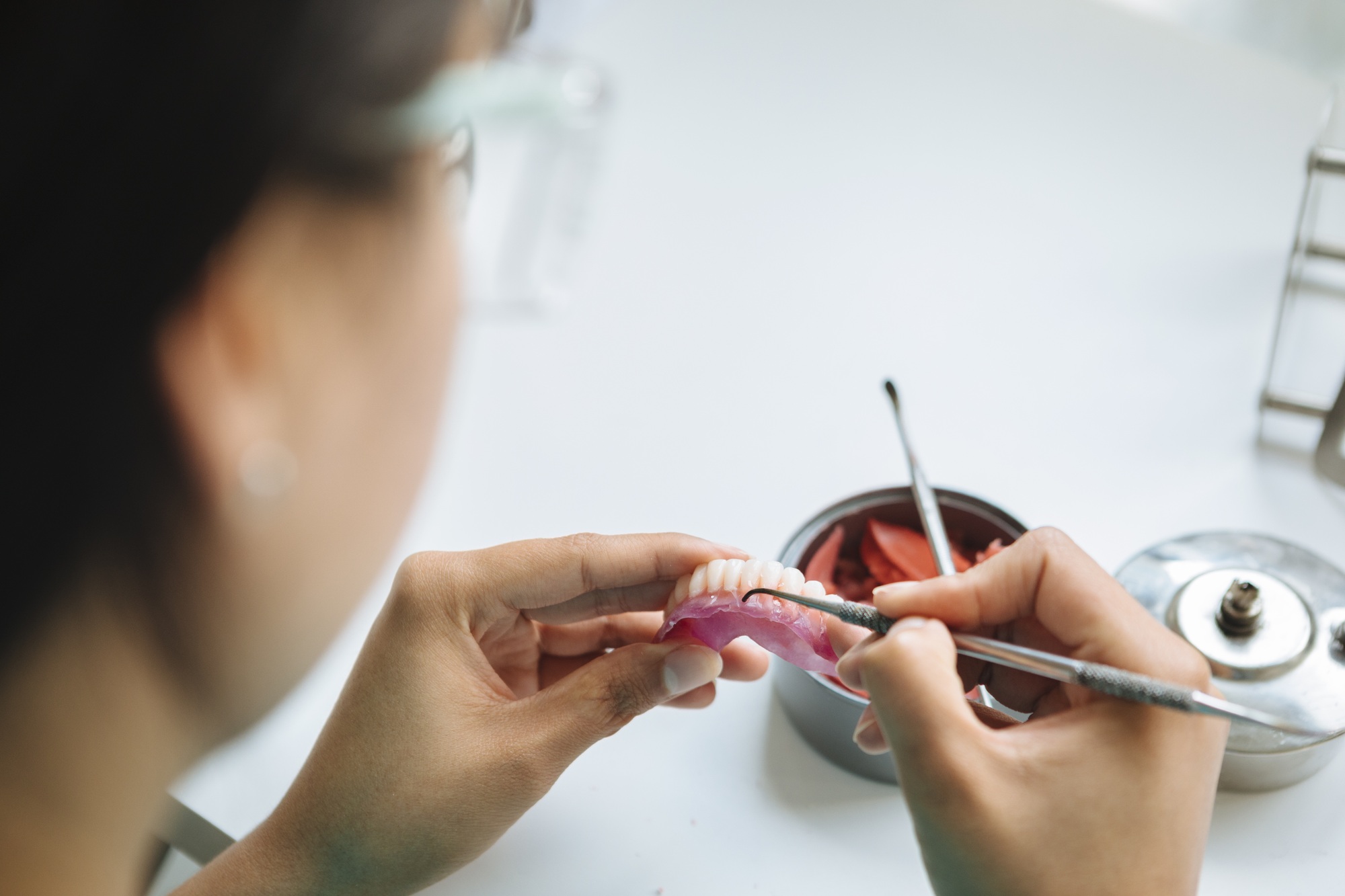 Closeup shot of hands working on a denture